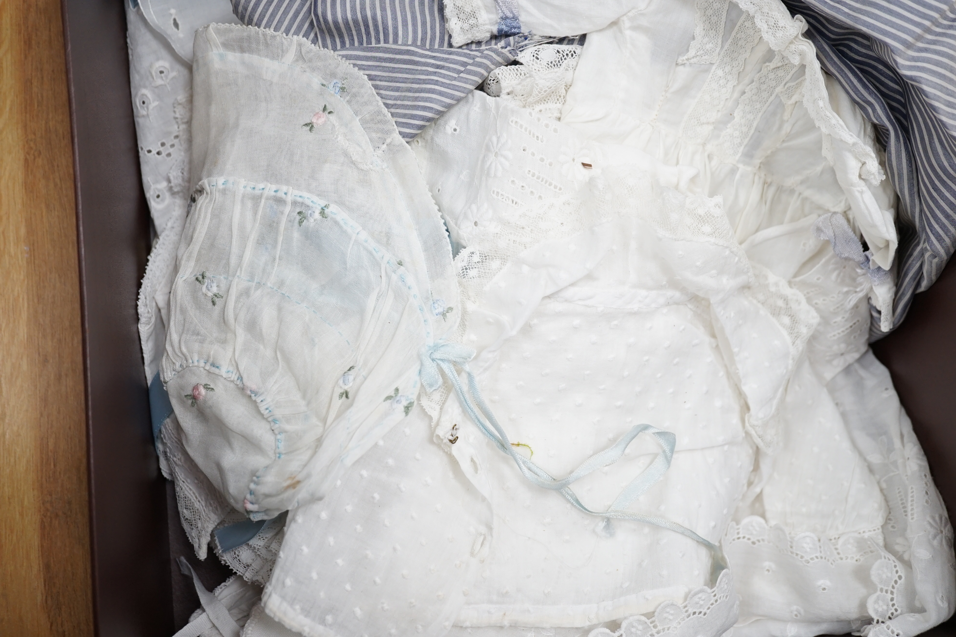 A small collection of doll's clothes from late 19th to mid 1930's, including a brown straw hat